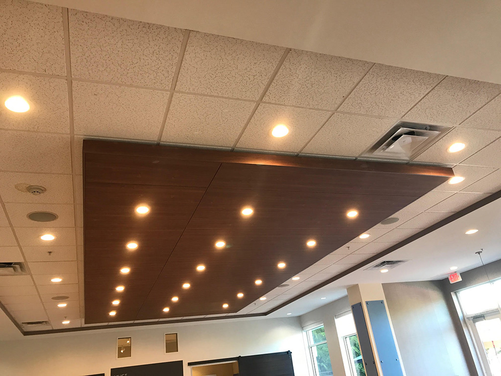 Custom woodwork panels for a grid of 18 lights on the ceiling of a local restaurant.