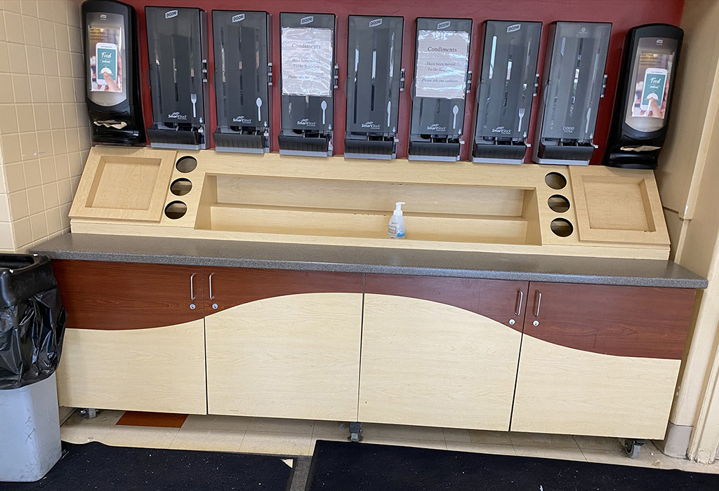 Custom condiment station at a restaurant, empty and not stocked yet.