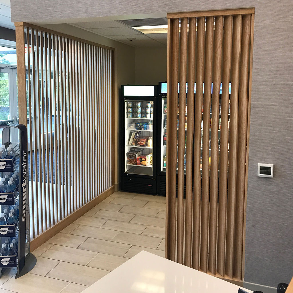 Custom vertical wooden slats around the entrance to a vending machine room.